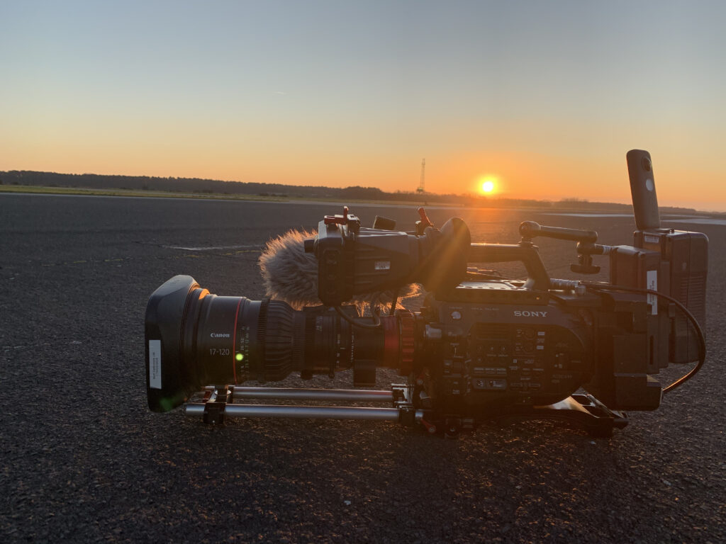 Picture of a runway at sunset with a Sony FS7 video camera in the foreground