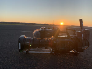 Picture of a runway at sunset with a Sony FS7 video camera in the foreground